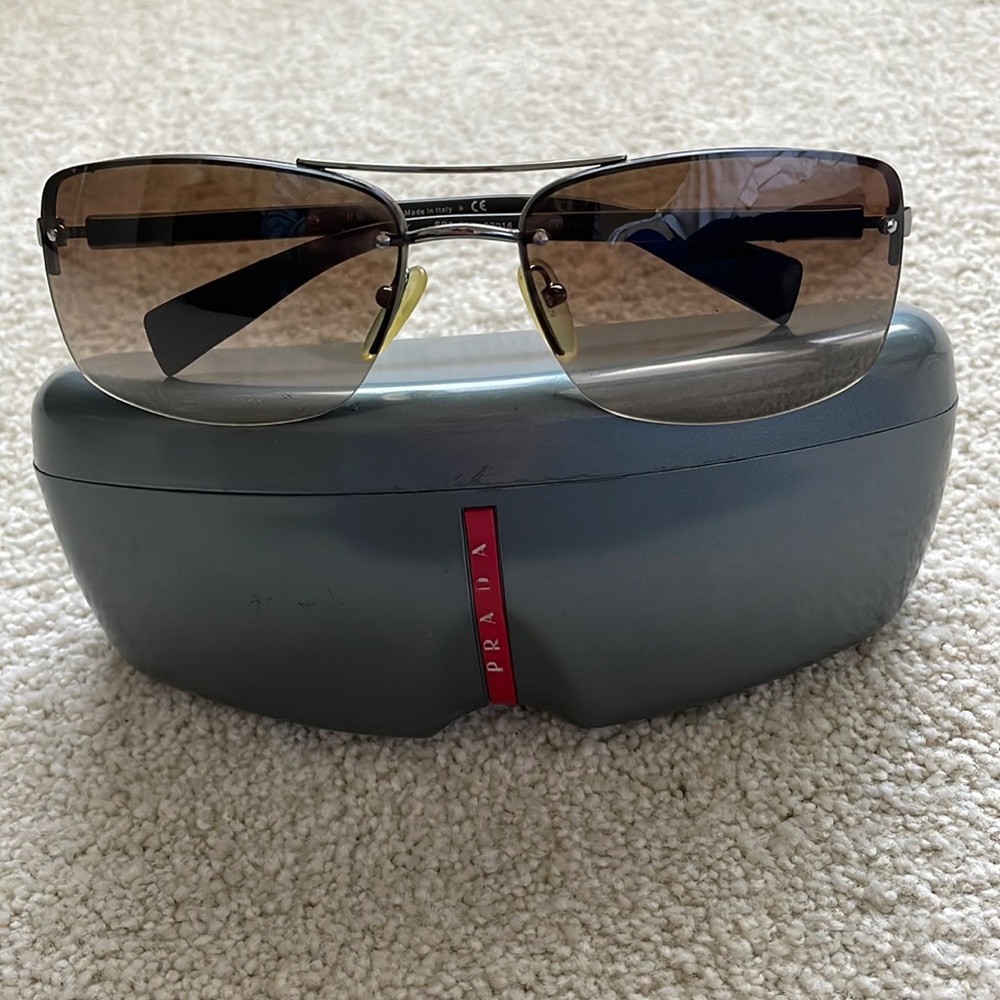 Prada - LIKE NEW sunglasses.  No scratches! Case included. Brown lenses.